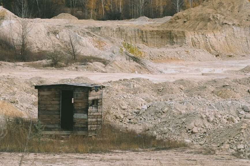 wooden hut among barren land in autumn