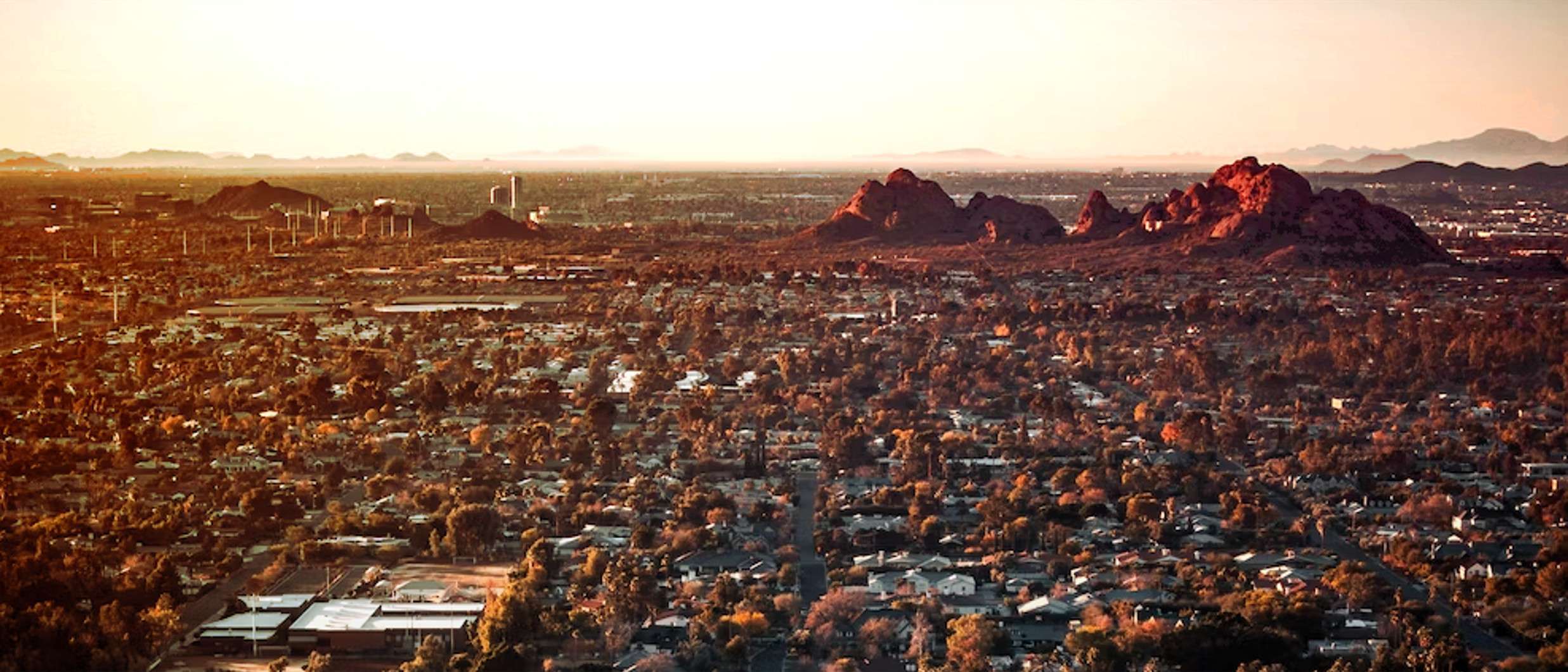 The Phoenix city skyline is seen shrouded in haze as temperatures soar to record highs.