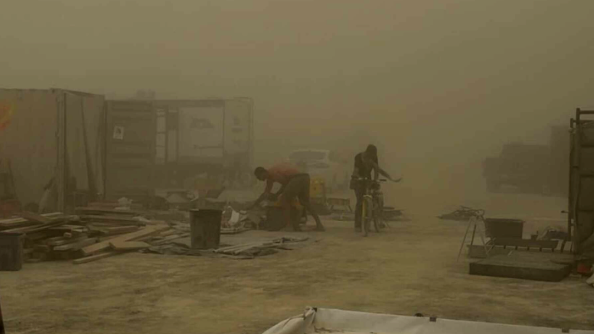 Burners endure harsh conditions as a powerful dust storm tears through Black Rock City, scattering debris and reducing visibility